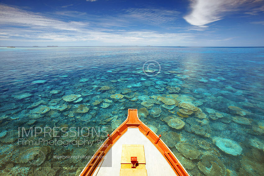 Maldives Traditional dhoni boat sailing on coral reefs