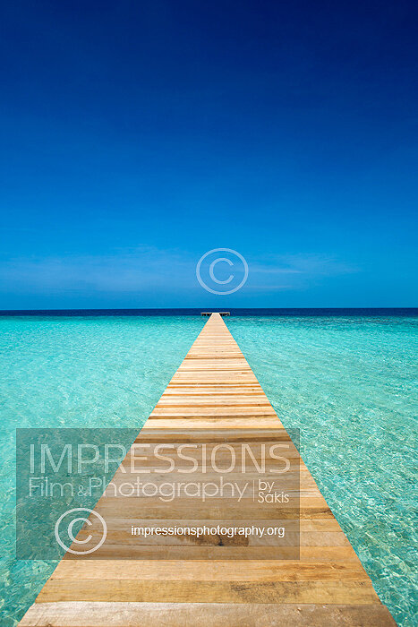 Maldives Stock photo of a wooden jetty out to tropical sea