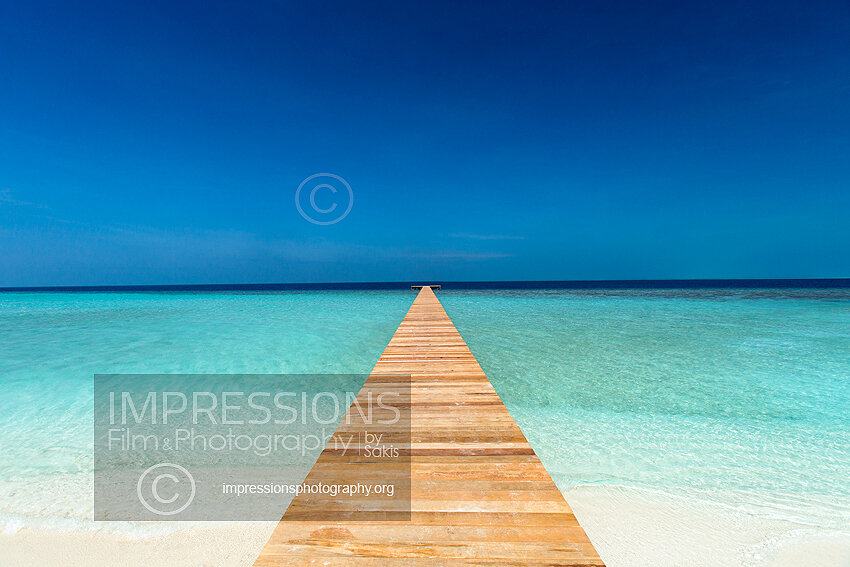 Maldives Stock photo of a wooden jetty out to tropical sea