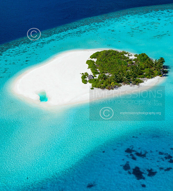 Aerial view of a beach and tropical desert island in the Maldives - stock photo