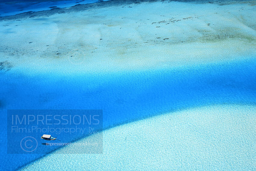 Maldives aerial view of lagoon and traditional boat dhoni