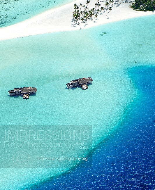 aerial view of water villas and tropical beach Gili Lankanfushi Resort Maldives