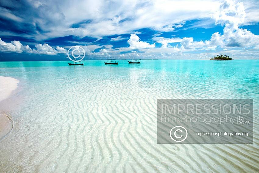 Maldives sandbank with Maldivian boats - Dhonis, turquoise lagoon and desert Island