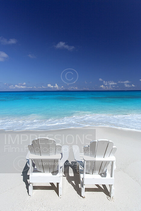Deck chairs on beach with lagoon view
