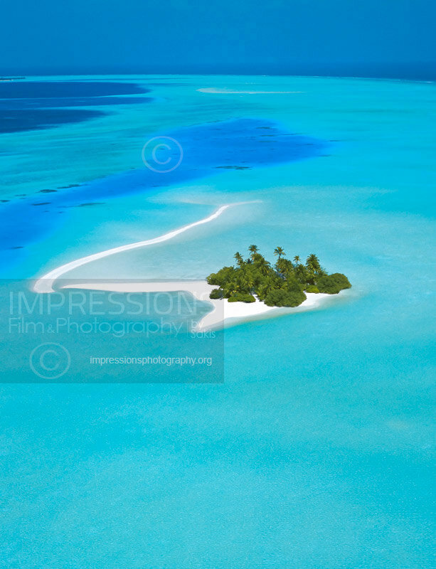 Aerial view of a beach and tropical desert island in the Maldives - stock photo