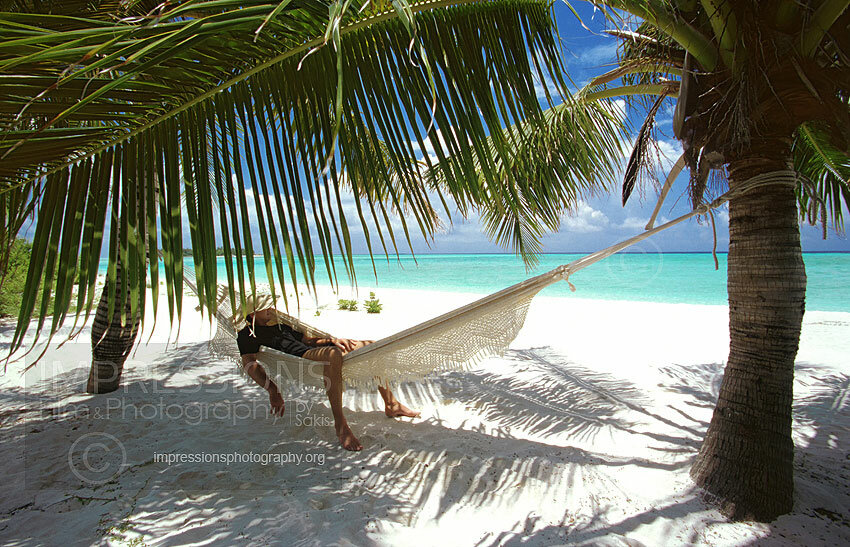 Man in hammock on a Maldives tropical beach