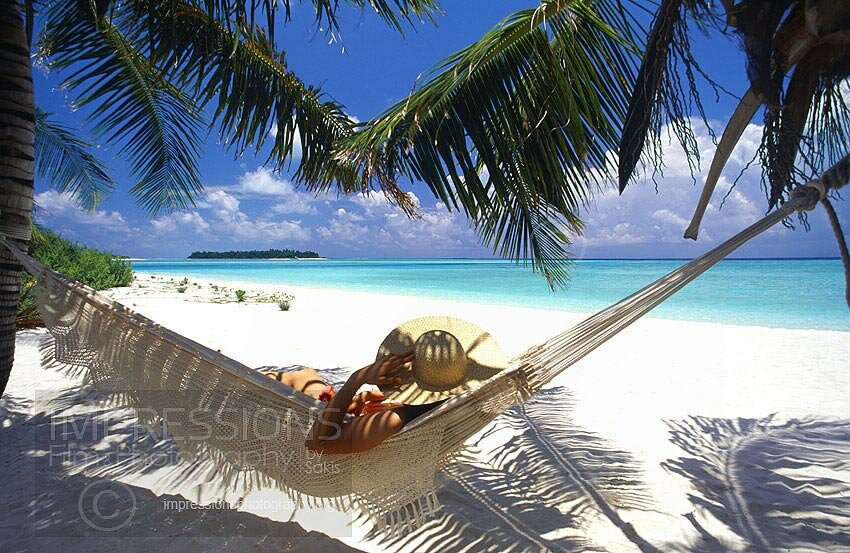 Woman in hammock on a Maldives tropical beach