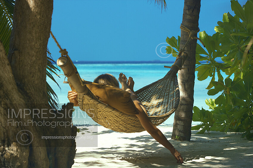 Woman in hammock on a Maldives tropical beach
