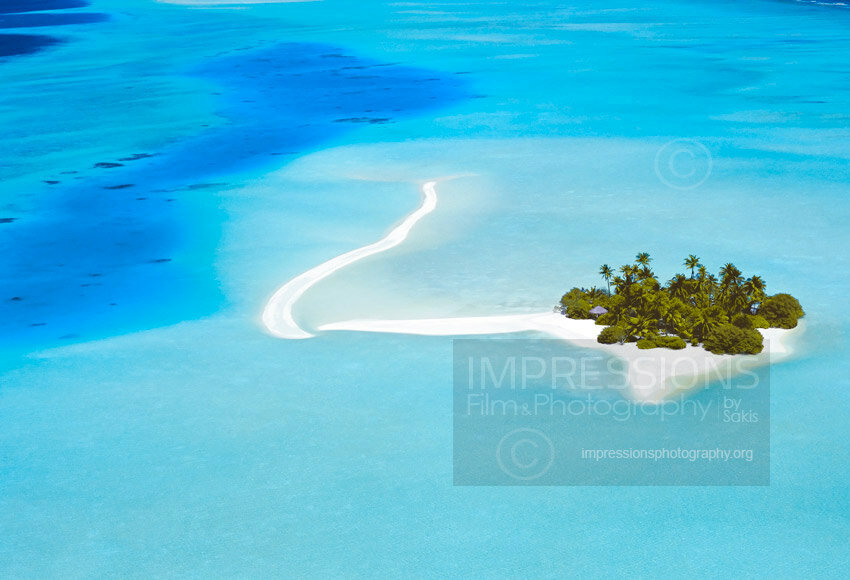 Aerial view of a beach and tropical desert island in the Maldives - stock photo