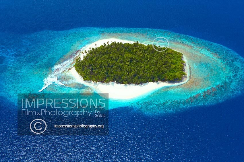 Aerial view of a beach Coral Reefs and island in the Maldives