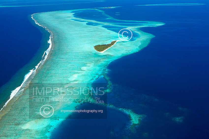 Maldives, Aerial view of coral reefs and island