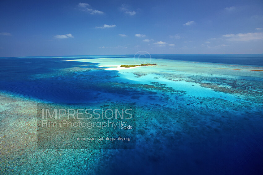 Maldives, Aerial view of coral reefs and island