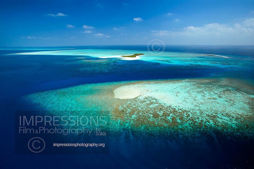 Maldives, Aerial view of coral reefs and island