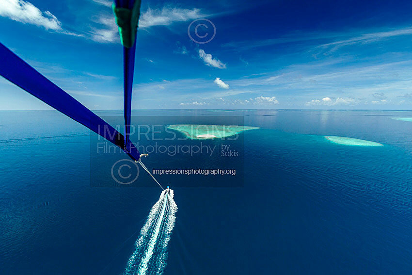Maldives, parasailing flying above atolls Aerial view of coral reef Stock photo