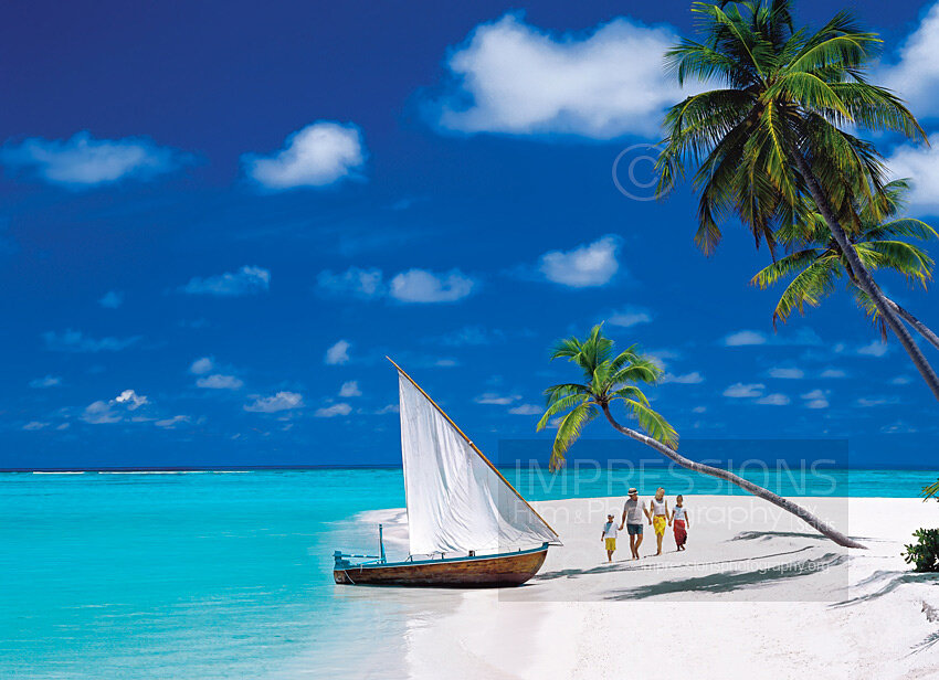 Family walking on a tropical beach Maldives stock photo