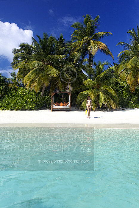 Swing on a Maldives tropical Beach and woman snorkeling