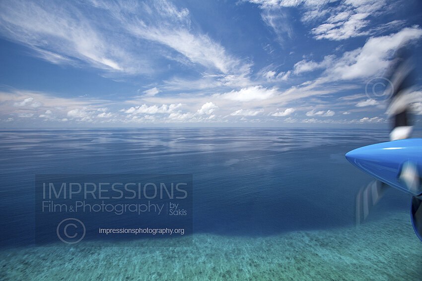 Maldives, seaplane flying above atolls Aerial view of coral reef Stock photo