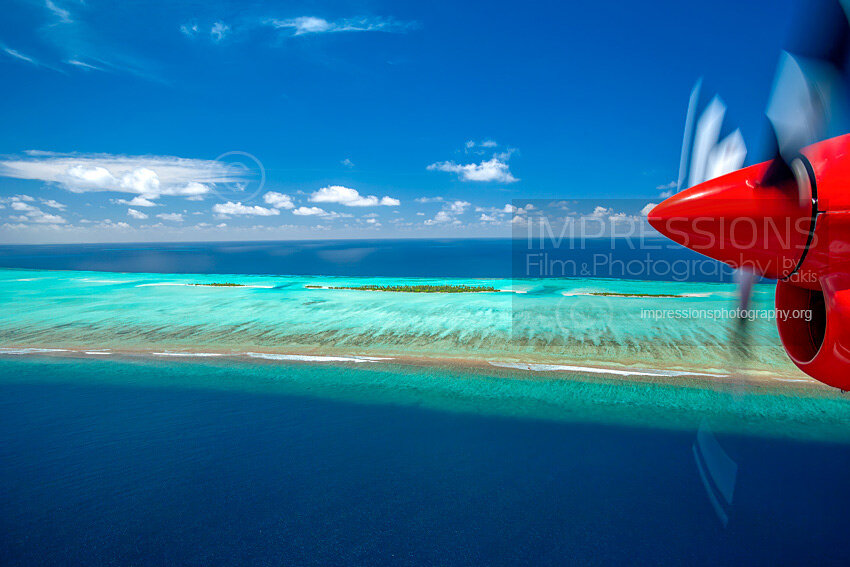 Maldives, seaplane flying above atolls Aerial view of coral reef Stock photo