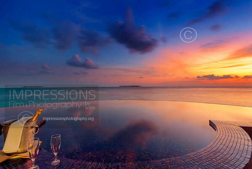 Maldives stock photo champagne and infinity swimming pool at sunset in a luxury resort water villa