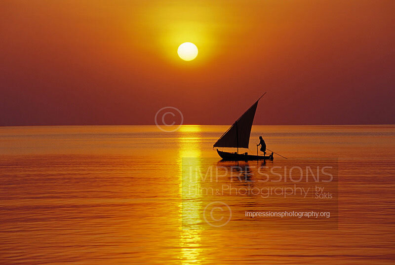 Maldives stock photo traditional Maldivian dhoni boat sailing at sunset