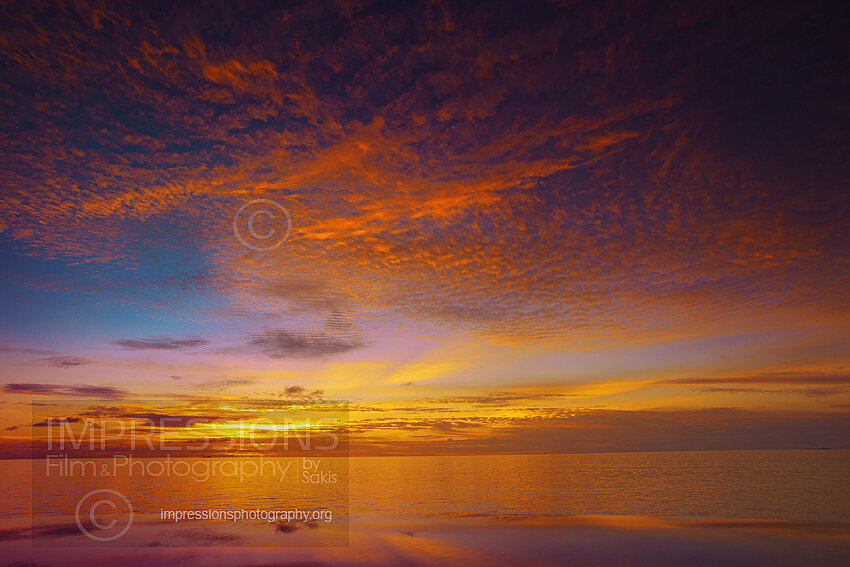 Maldives sunset from infinity pool with reflection and ocean views stock photo
