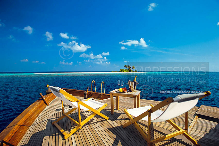 maldives lounge chairs on traditional maldivian dhoni boat deck with cocktails overlooking tropical island stock photo
