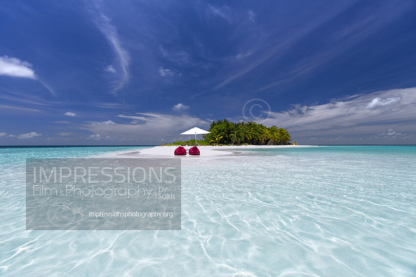 maldives stock photo lounge chairs and sun umbrella on tropical beach stock photo