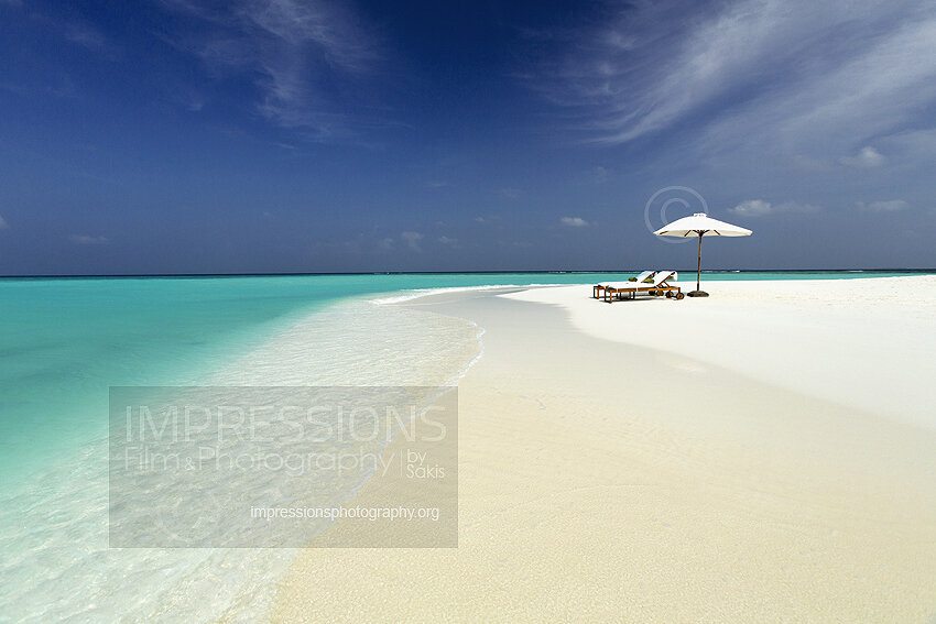 maldives stock photo lounge chairs and sun umbrella on tropical beach stock photo