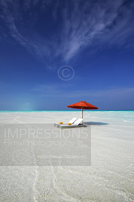 maldives stock photo lounge chairs and sun umbrella on tropical beach stock photo
