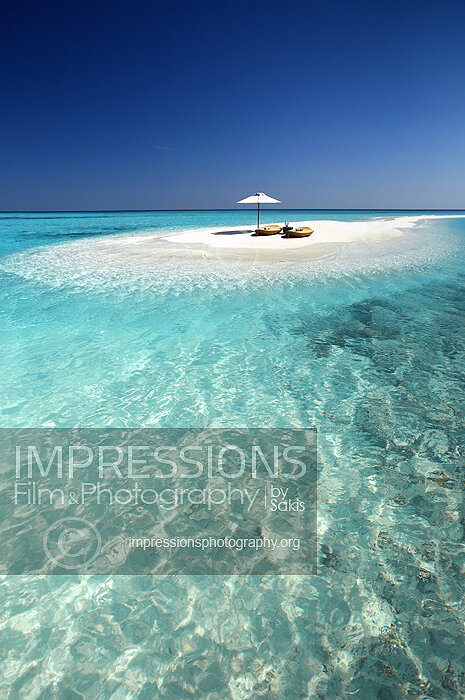 maldives stock photo lounge chairs and sun umbrella on tropical beach stock photo