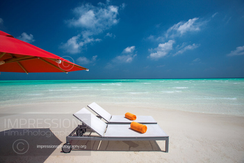 maldives stock photo lounge chairs and sun umbrella on tropical beach stock photo