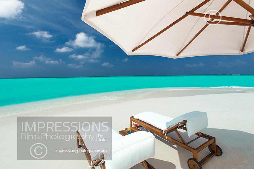 maldives stock photo lounge chairs and sun umbrella on tropical beach stock photo
