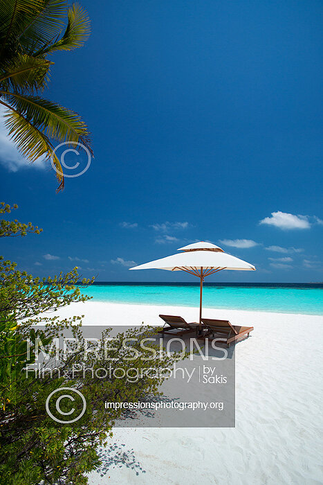 maldives stock photo lounge chairs and sun umbrella on tropical beach stock photo