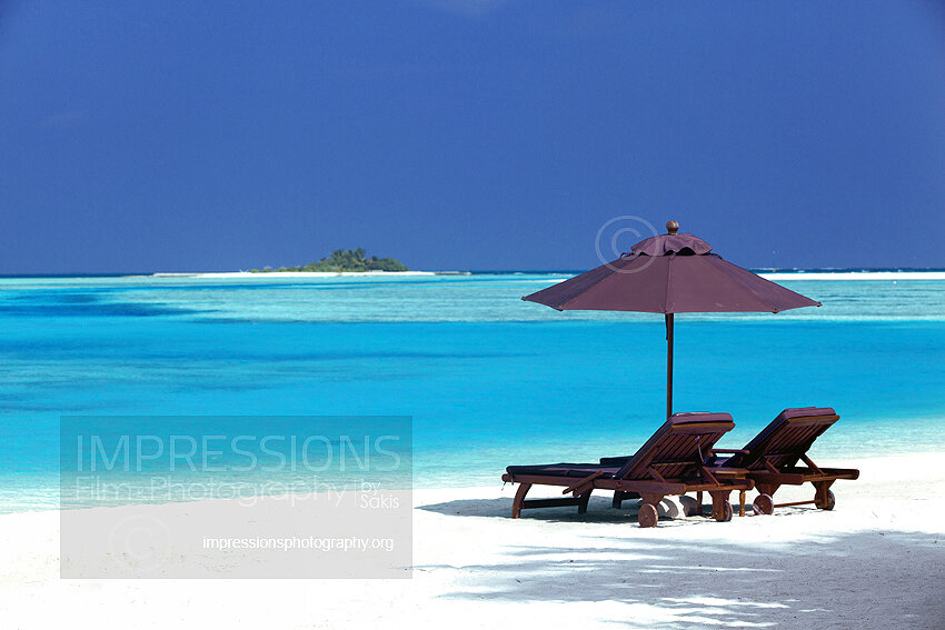 maldives stock photo lounge chairs and sun umbrella on tropical beach stock photo