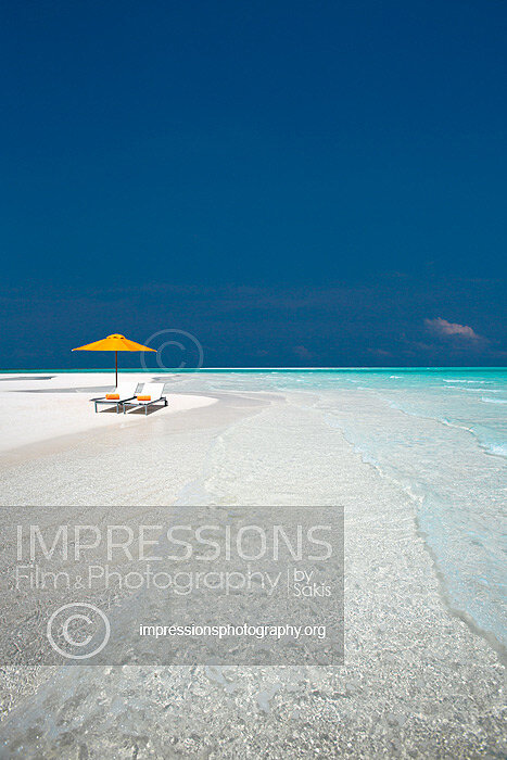 maldives lounge chairs and sun umbrella on tropical beach