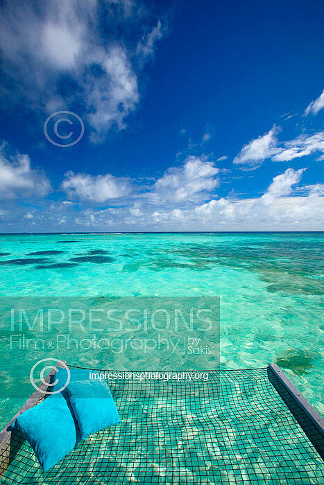 Maldives, overwater Hammock bed hanging over turquoise blue lagoon in luxury resort stock photo