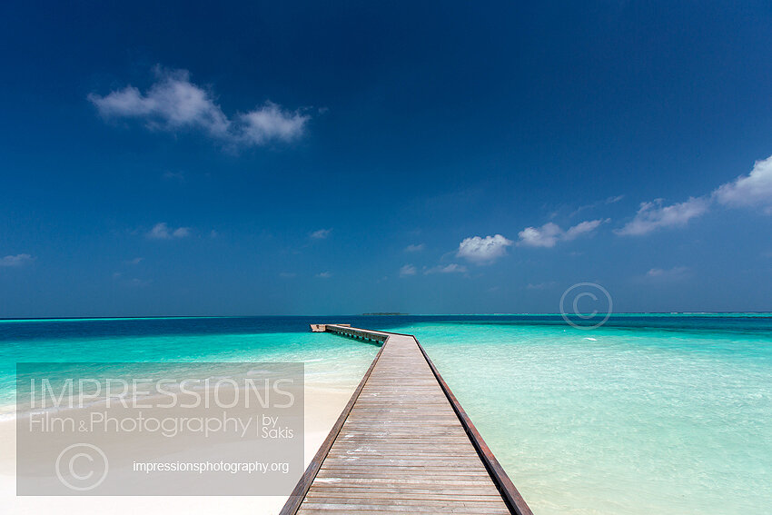 Maldives, wooden jetty out to tropical sea