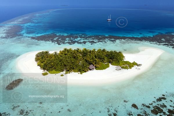 Aerial view of Tropical island, lagoon and boat, Maldives stock photo