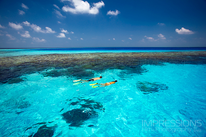 Lifestyle photography. Couple snorkeling in the resort lagoon