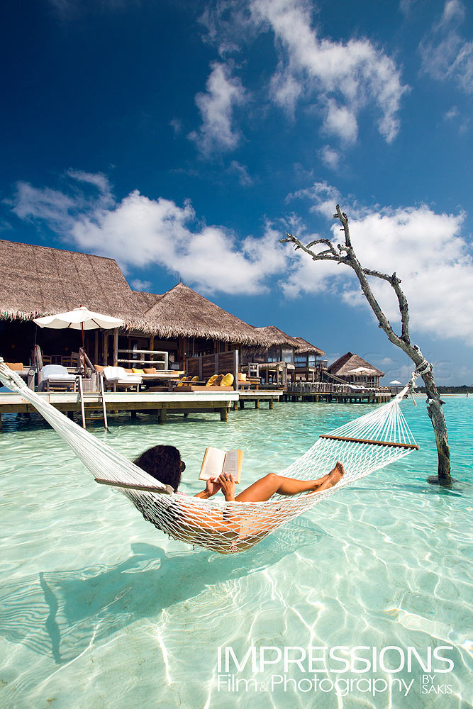 Lifestyle photography Guest relaxing in a hammock - Luxury Water Villa Gili Lankanfushi Maldives