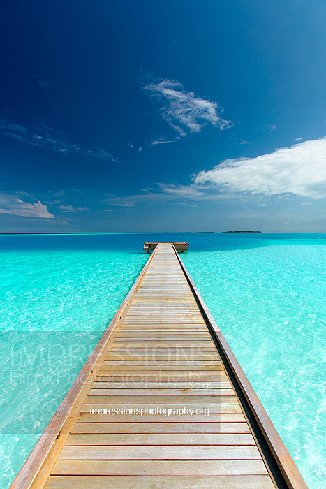 maldives wooden jetty leading to Ocean