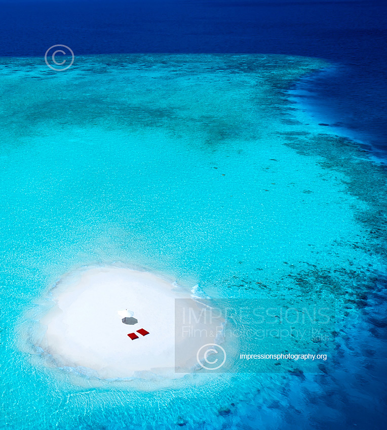 Aerial view of a sandbank and turquoise waters in the Maldives - stock photo