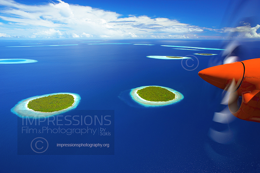 maldives seaplane flying above baa atoll  