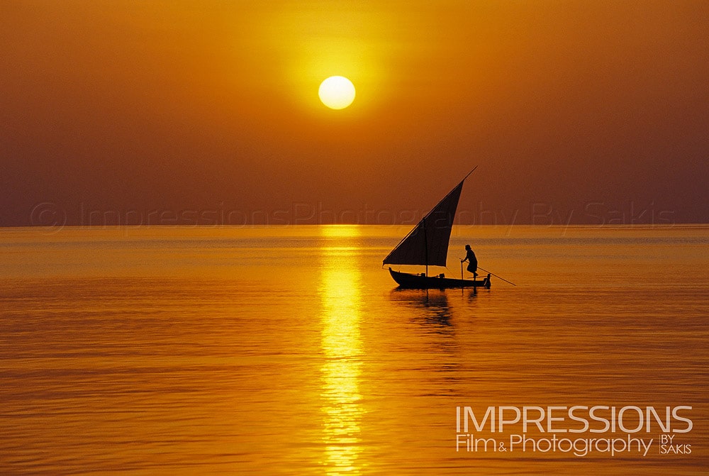 Maldivian boat sailing at sunset the Dhoni