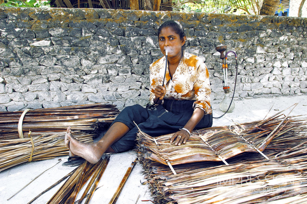 Maldivian lady smoking hookah on a local island - photos of the people of Maldives series