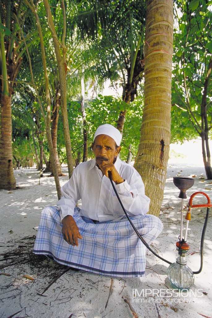 portrait of a man relaxing with his hookah Maldives local island - photos of the people of Maldives series