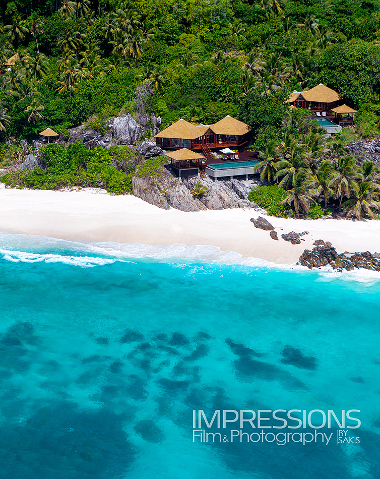 Private Island aerial photographer - Fregate Island Seychelles aerial photography at luxury villa on cliff from helicopter