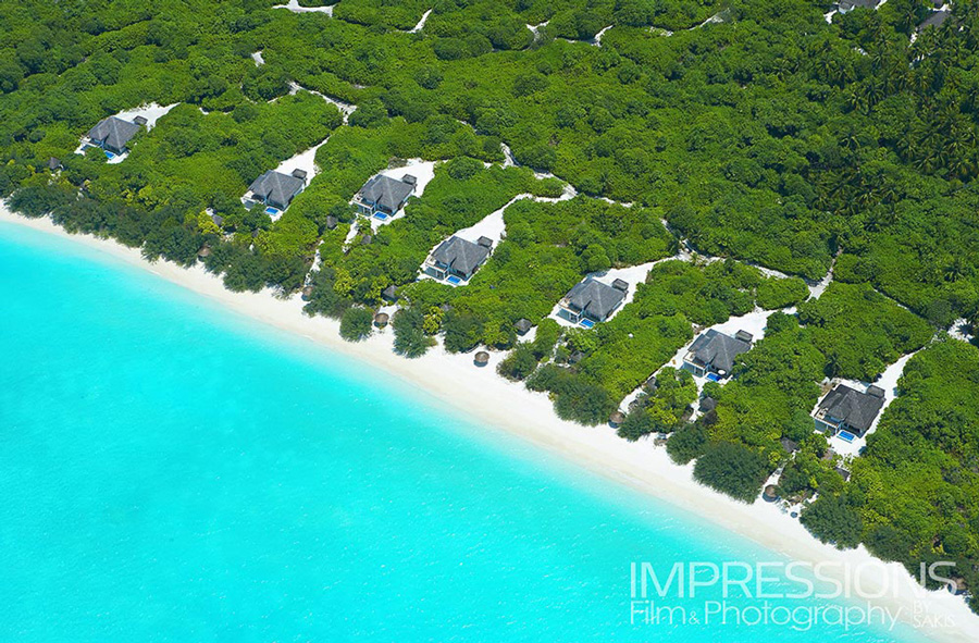 professional hotel aerial photography from a plane - Aerial view of the villas captured at a low altitude