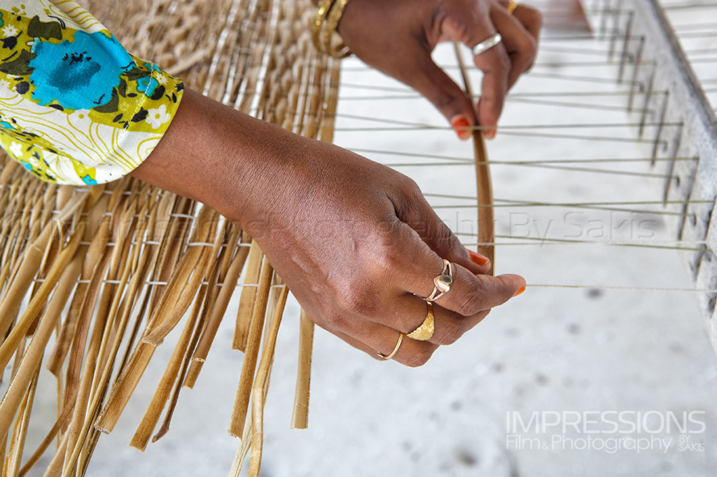 Maldives tradition hands of a Maldivian woman weaving Coconut leaves to make mats called Kunaa.